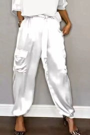 White satin cargo pants with drawstring waist and cuffed ankles