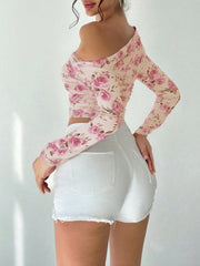 Asymmetrical floral ruched blouse with long sleeves and off-the-shoulder neckline.