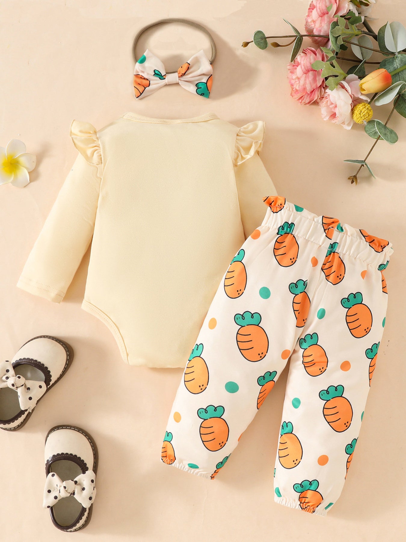Baby girl's yellow ruffled long sleeve bodysuit and carrot print pants with matching bow headband.