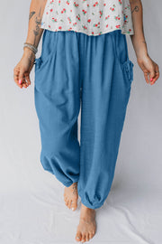 Blue cotton blend jogger pants with smocked waist, pockets, and drawstring details.