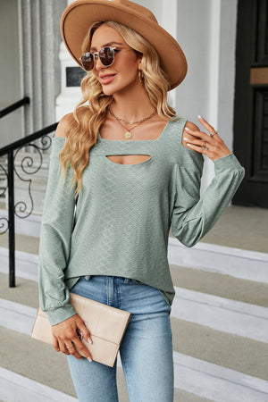 Sage green textured open shoulder blouse with keyhole neckline and long sleeves.