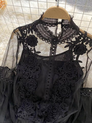 Black lace blouse with floral embroidery and sheer sleeves, paired with a cami.