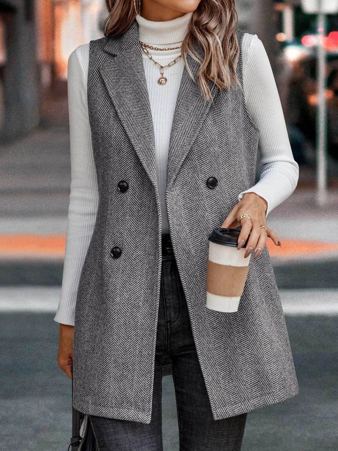Herringbone double-breasted vest in dark gray with a collared neckline and buttoned front.