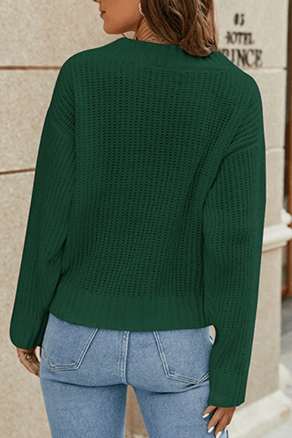 Dark green knit v-neck pullover sweater with a relaxed fit and subtle open knit detail.