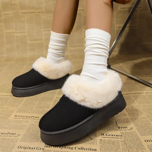 Black suede platform slippers with plush cream faux fur trim and white slouch socks.