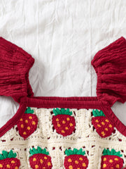 Crochet baby jumpsuit in burgundy with strawberry pattern and ruffle sleeves