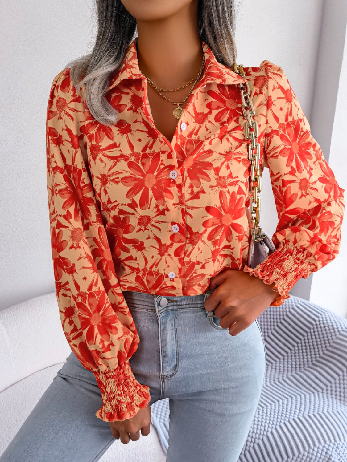 Floral print shirred cuff blouse in pumpkin with button front and collared neckline.
