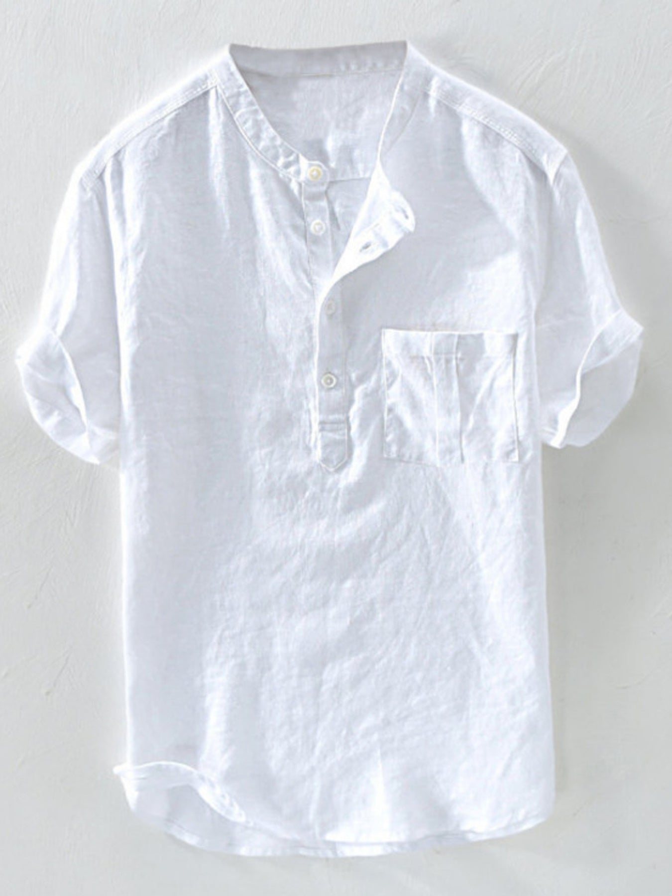 White casual shirt with band collar, buttoned placket, and chest pocket.