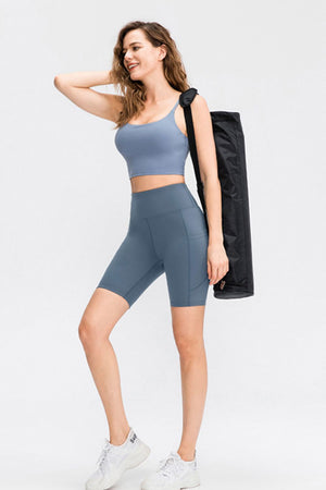 Sculpting pocketed cycling shorts in light blue with a high waist and side pockets.