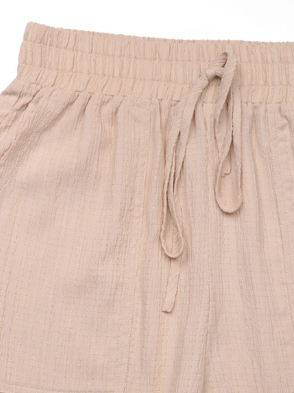 Tan textured drawstring cargo trousers with elastic waistband and tie detail.