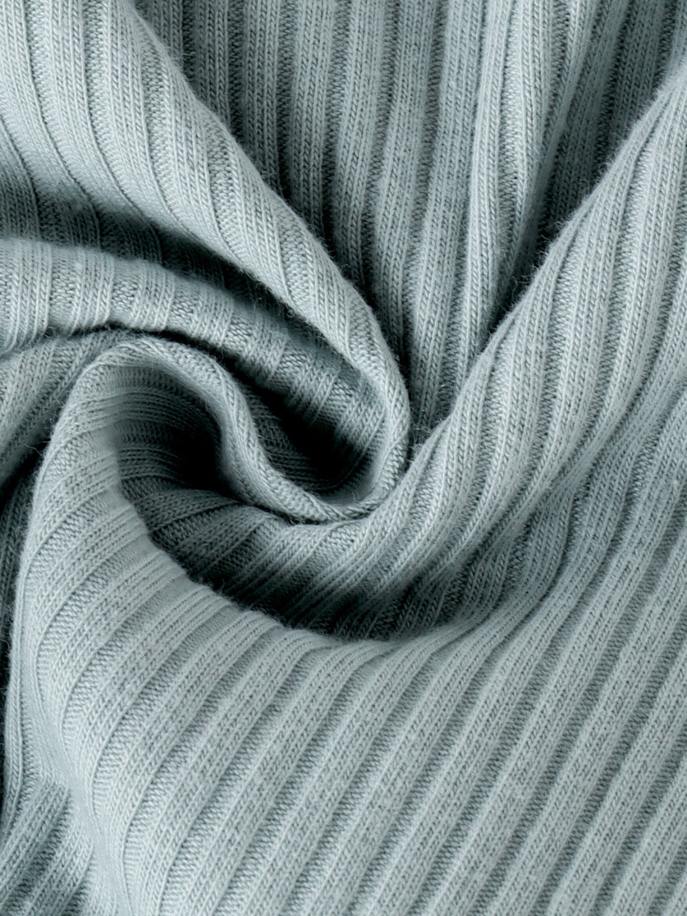 Green ribbed knit fabric detail