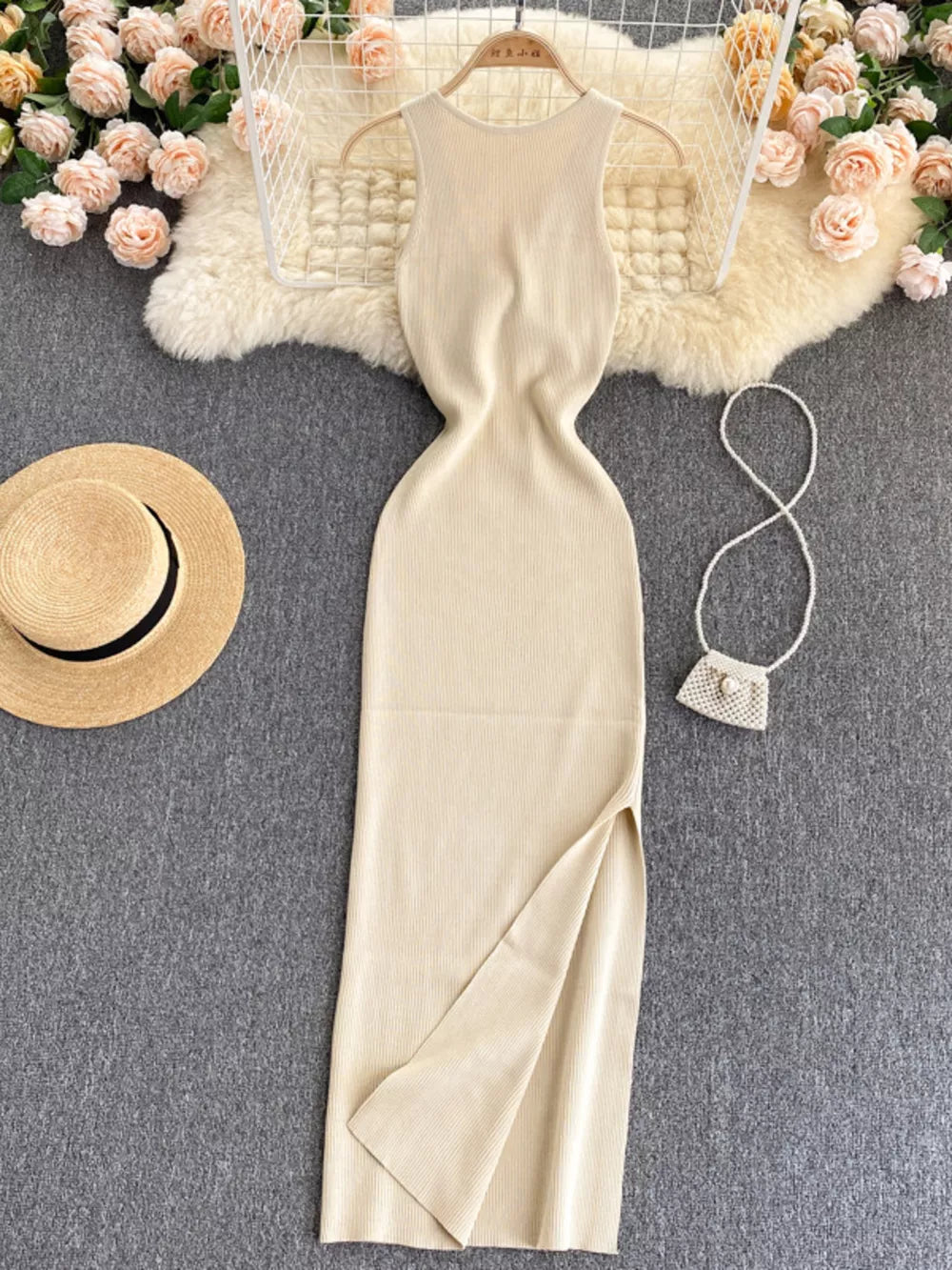 Ribbed knit midi dress in beige with a high slit and sleeveless design.