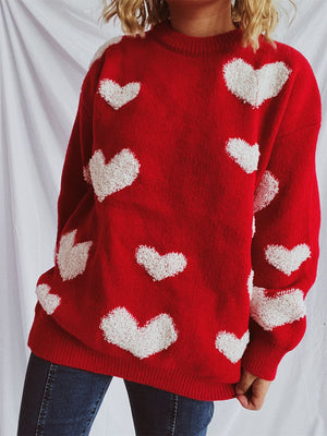 Red acrylic sweater with textured white heart appliqués and a crew neck.