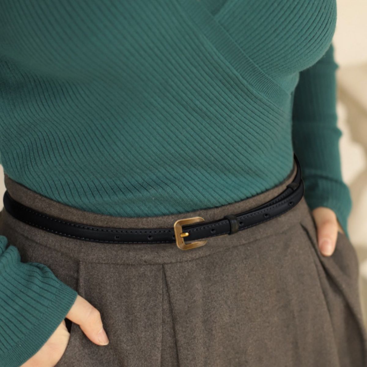 Black cowhide leather accent belt with antique brass buckle and punched holes detail.