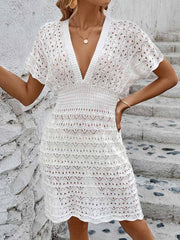 White openwork knit beach mini dress with V-neck and short sleeves.