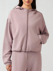 Dusty pink cropped active hoodie with zipper, raglan sleeves, and pockets.