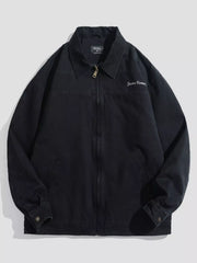 Men's black casual zip-up jacket with embroidered "DESIGN HOMME" detail and collar.