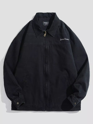 Men's black casual zip-up jacket with embroidered "DESIGN HOMME" detail and collar.