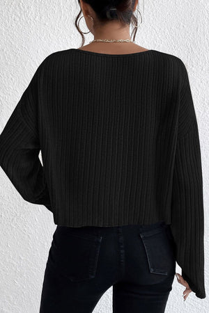 Black ribbed knit off-shoulder top with long sleeves and a cropped hem.