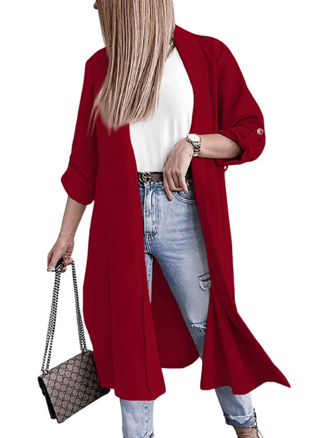 Deep red draped-front maxi coat with button cuffs and rolled sleeves, worn open over a white top and jeans.