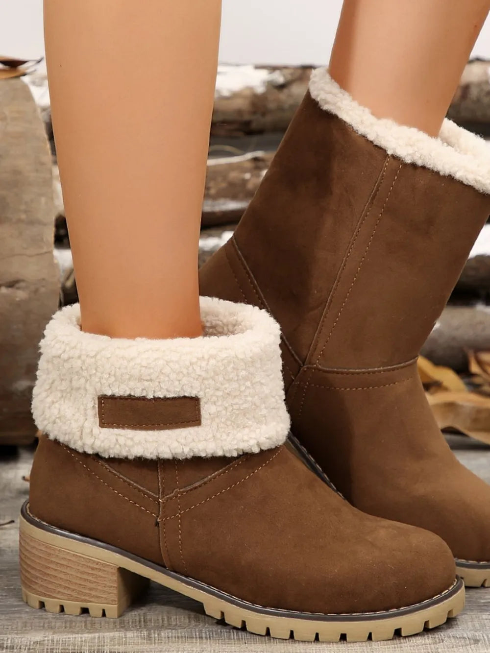 Brown suede ankle boots with sherpa trim and lug sole.