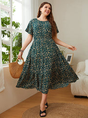Emerald floral midi dress in deep teal with flutter sleeves and tiered skirt.