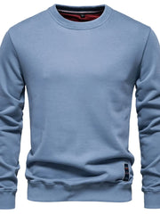 Light blue crewneck sweatshirt with subtle patch detail on hem