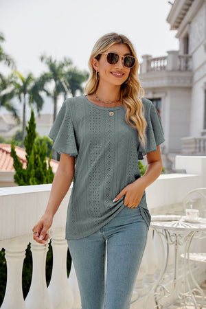 Sage eyelet flounce sleeve crew neck top with allover geometric perforations.