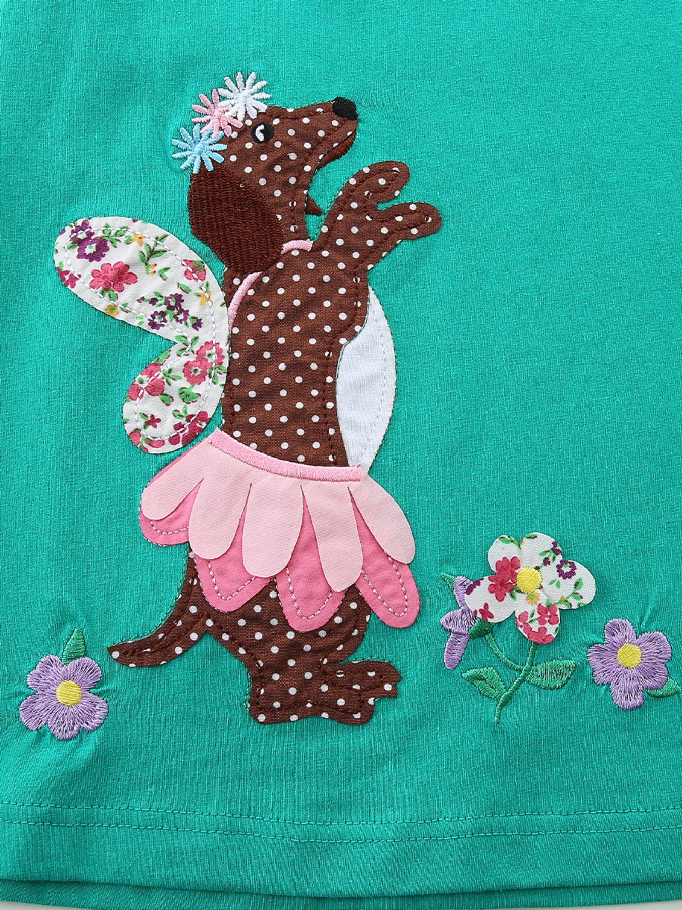 Toddler dress with embroidered brown polka dot dog design, floral wings, and pink petal skirt.