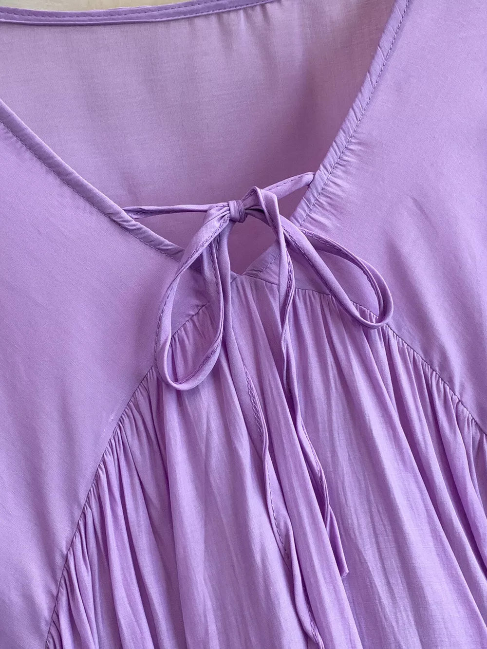 Purple bohemian maxi dress with tie-neck detail and gathered skirt