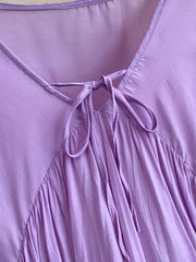 Purple bohemian maxi dress with tie-neck detail and gathered skirt
