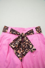 Pink chino shorts with high waist and leopard print belted bow detail.