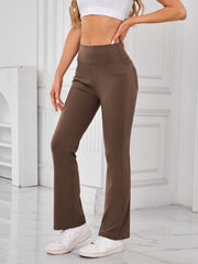 Brown flared activewear pants with pocket detail and high waist