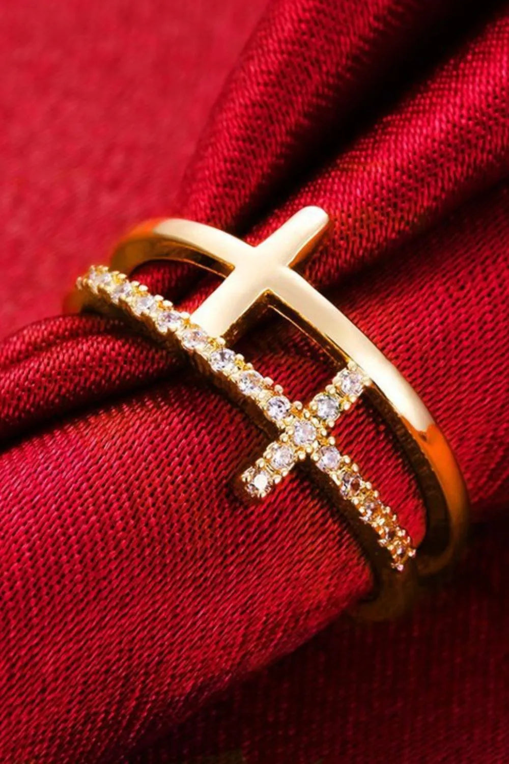 Gold double band ring with cross embellishment and clear stones