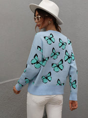 Sky blue knit crewneck sweater with allover butterfly motif and crew neckline.