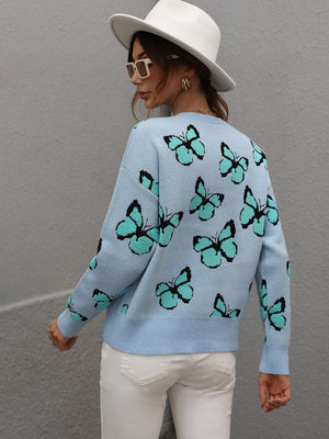 Sky blue knit crewneck sweater with allover butterfly motif and crew neckline.