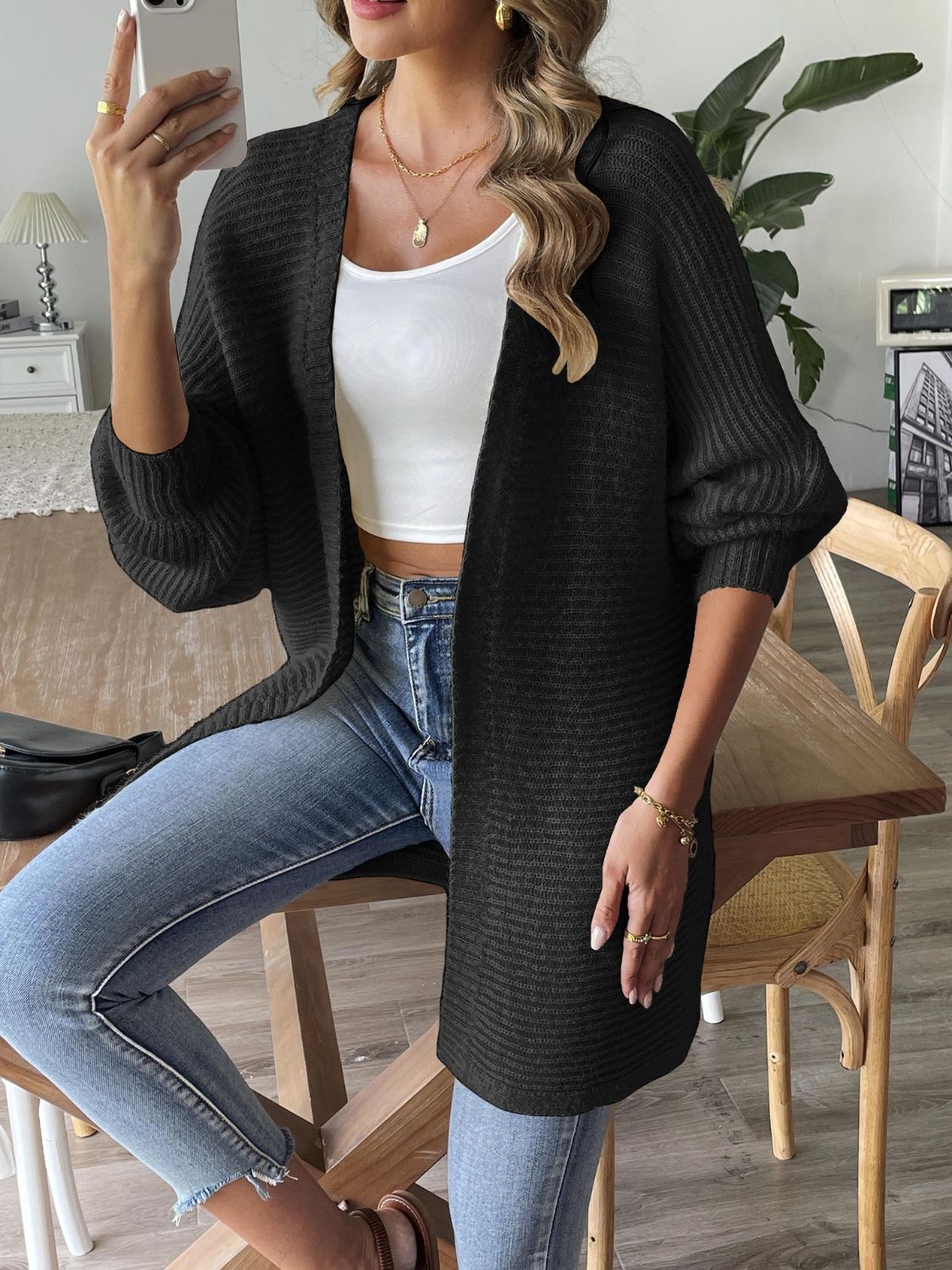 Black ribbed knit dolman sleeve cardigan with open front and relaxed fit.