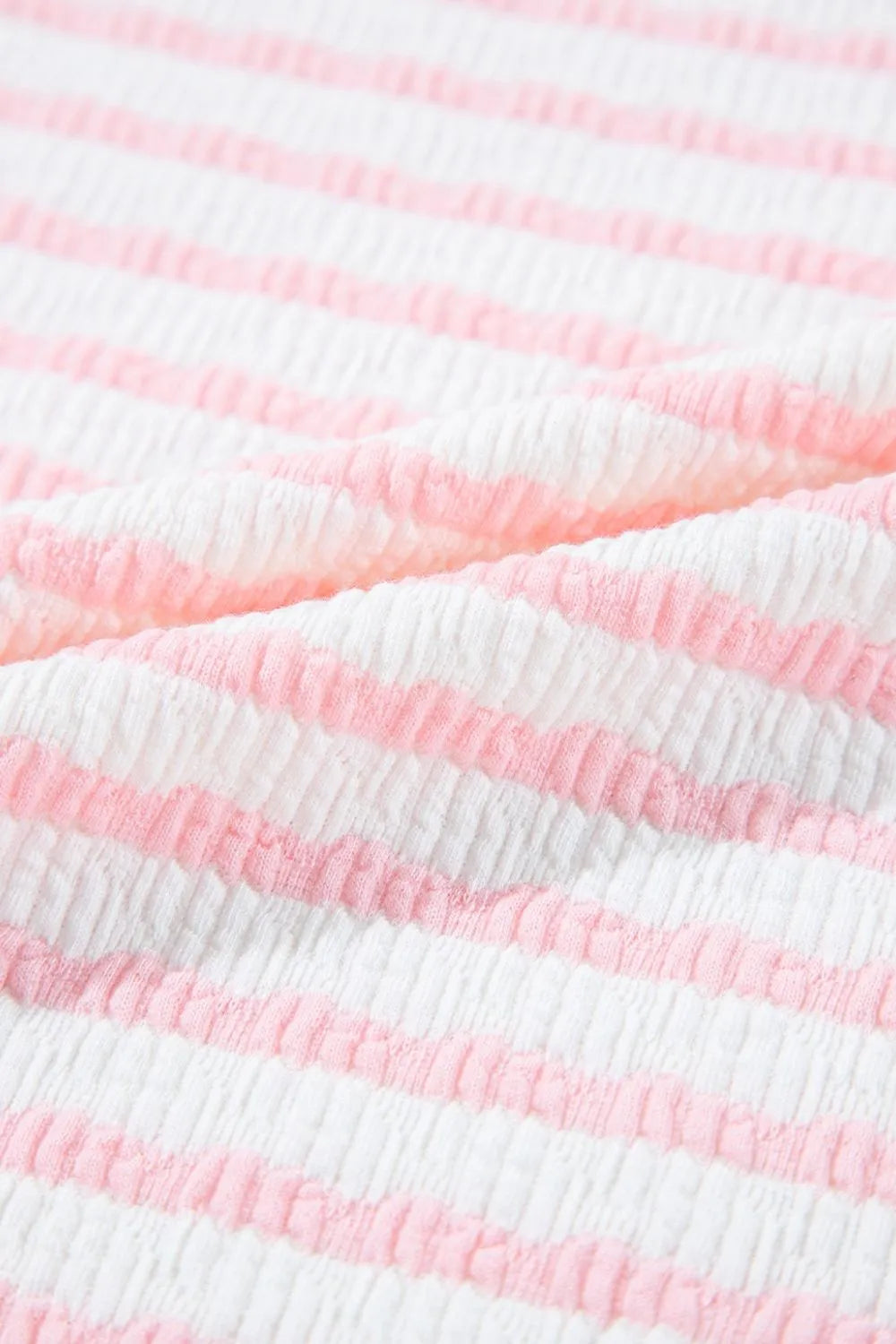 Textured blush pink and white striped loungewear fabric detail