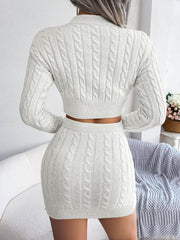 White cable knit crop co-ord set with a mini skirt and long sleeve sweater.