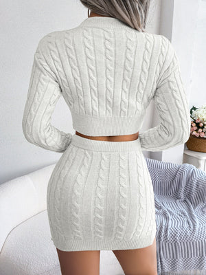 White cable knit crop co-ord set with a mini skirt and long sleeve sweater.