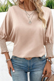 Satin batwing blouse in beige with shirred cuffs and crew neck.