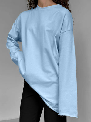 Light blue oversized cotton jersey top with long sleeves and crewneck, styled casually.