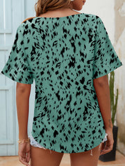 Relaxed notch neck top in turquoise with black dalmatian print and short sleeves.