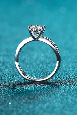 Silver crossover moissanite solitaire ring with pavé detail on band