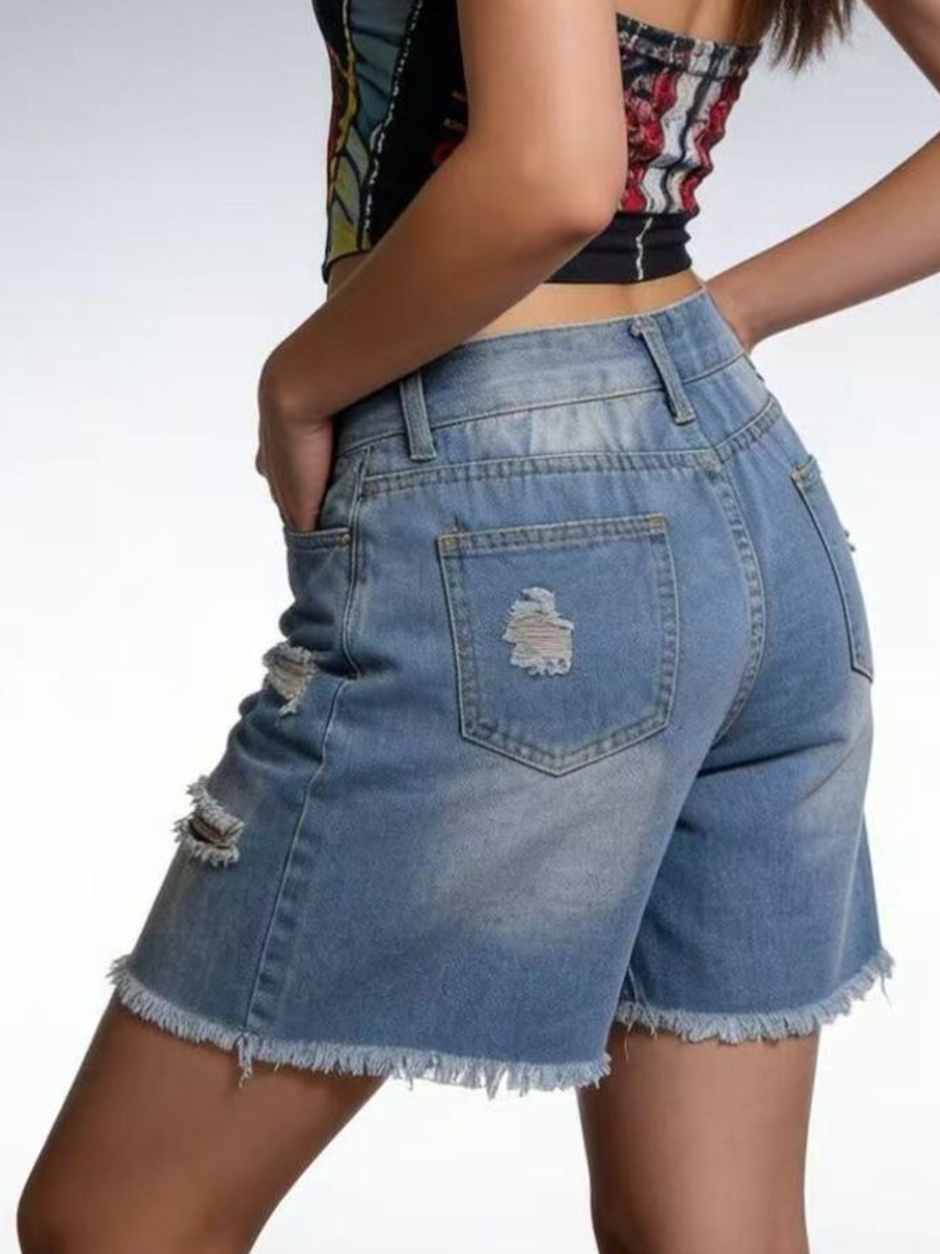Light blue distressed denim shorts with frayed hem and ripped details.