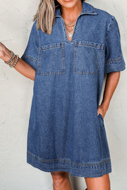 Medium blue denim utility mini dress with collar, short sleeves, two chest pockets and side pockets.