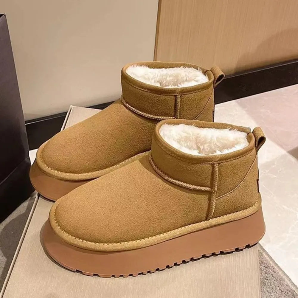 Shearling platform ankle boots in camel with fluffy white lining and a thick sole.