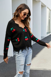 Black v-neck knit sweater with frayed hem and cherry motif, long sleeves.