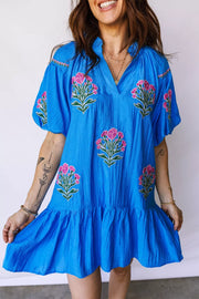 Blue embroidered floral dress with short sleeves and ruffle hem.