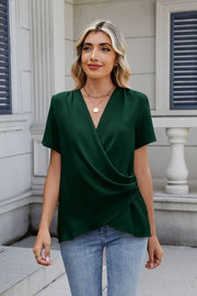 Dark green draped front short sleeve blouse with a V-neck and asymmetrical hem.